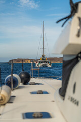 View from sailboat deck toward another sailboat near Delos island Greece © Juan