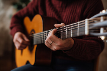 Fototapeta premium A close-up view of a skilled musician strumming an acoustic guitar, capturing the passion and artistry involved in creating music that connects people.