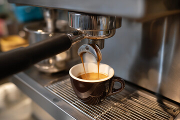 A close-up shot of rich espresso being perfectly brewed and poured into a stylish coffee cup, showcasing the allure of freshly made coffee.