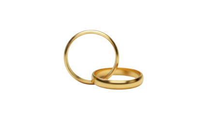 Two gold wedding bands or engagement rings one standing upright on its side and the other lying down on a plain