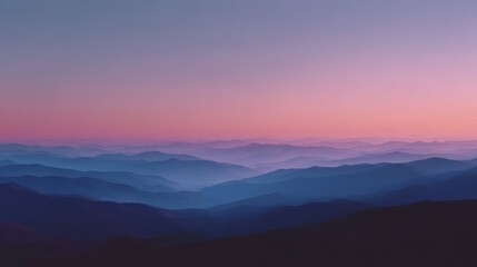 Serene mountain landscape at dawn with layers of blue and pink.