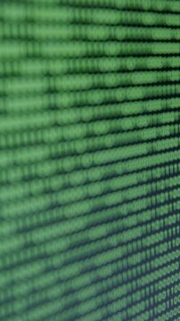 Close-up view of cascading binary code on a digital screen, showcasing a hacker cyber attack, with gradual zoom in revealing intricate data patterns and flow