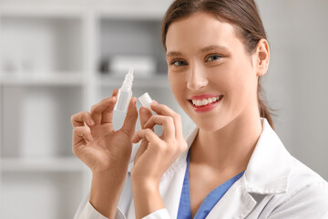 Female ophthalmologist with eye drops in clinic, closeup