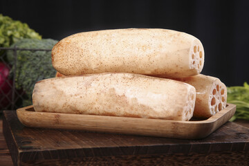 Fresh Lotus Root with Holes on Wooden Board