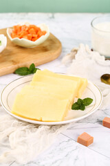 Fresh German Cheese Block Slices with Ingredients on Marble Countertop