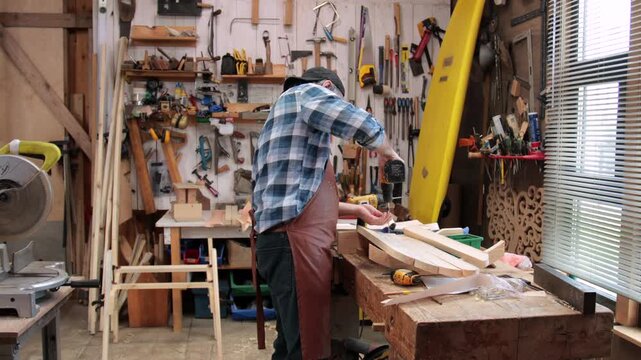 A carpenter assembles an Adirondack chair