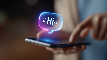 Hands holding phone displaying glowing hi message communication image