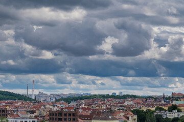 Fototapeta premium Breathtaking panoramic view of Prague, showcasing its historic city center with iconic buildings, charming red-roofed houses.