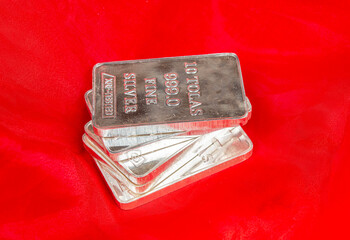 Closeup view of Fine Silver Bars on red background
