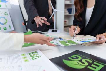 Business professionals analyzing environmental, social, and governance - ESG - performance data and planning sustainable corporate strategies