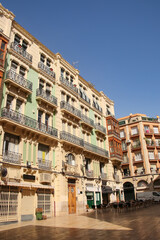 Obraz premium Beautiful and historic buildings surrounding the Plaza de Santa Maria in the old town, with ornate iron balconies and brick work, Alicante, Costa Blanca, Spain.
