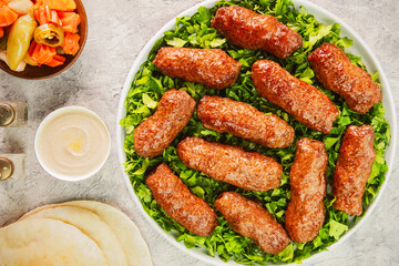 Arabic Cuisine; Grilled Kofta Kebab is one of the most popular dishes in Egypt and entire Mediterranean region. Served on bed of fresh parsley with pita bread, tahini sauce and pickles.