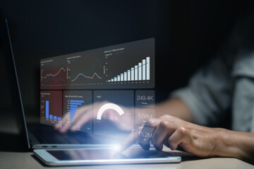 Man is using a laptop to analyze and track sales growth, comparing year-on-year sales. business dashboard interface with analytics widgets including charts, graphs, and statistics.