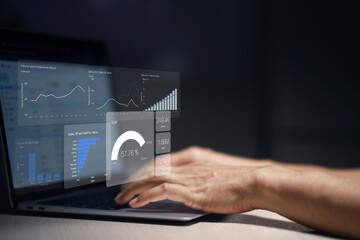 Man is using a laptop to analyze and track sales growth, comparing year-on-year sales. business dashboard interface with analytics widgets including charts, graphs, and statistics.