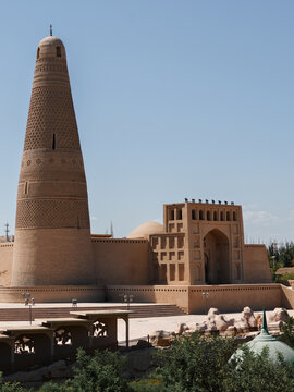 View of the Emin Minaret stands tall against the clear blue sky, contrasting with the tan brickwork in Turpan, Xinjiang, China.