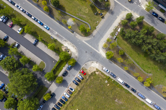 Aerial view of cars neatly parked in designated lots, contrasting with green spaces and intersecting roads, Bremen, Bremen, Germany.