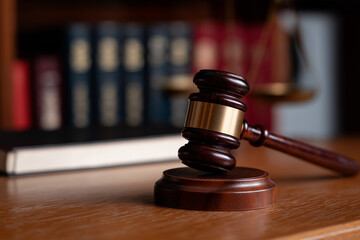 A symbolic representation of justice with a wooden gavel resting prominently in the foreground, complemented by law books, encapsulating the essence of legal authority and integrity.