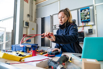 Woman engineer working electrical wiring solar energy system © pacoocimage