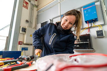 Woman electrician working on solar power installation