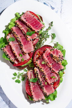 Breakfast, sandwiches, fried tuna fillet, in sesame seeds, no people, top view, homemade,