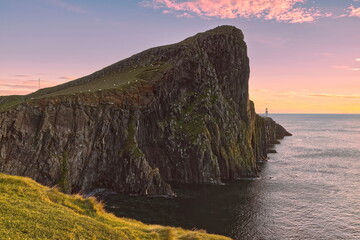 The 122m high An t-Aigeach (Stallion Head) crag and the Neist Point lighthouse, at early sunset from the Duirinish Peninsula cliffs. Skye-Scotland-151
