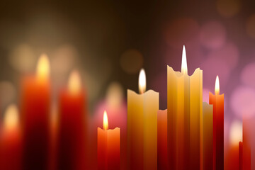A collection of softly glowing candles set against a blurred background, creating a warm and inviting atmosphere perfect for relaxation and fostering a sense of calm and peace.