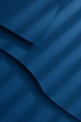 Abstract composition of overlapping blue paper sheets creating a layered effect. Light and shadow patterns cross diagonally, adding depth and texture. The shades of blue vary subtly, 