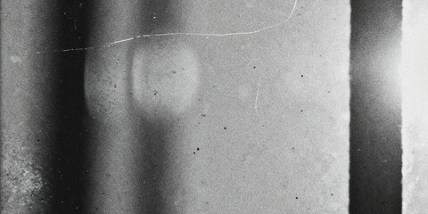 A grayscale close up reveals a textured abstract surface with subtle tonal variations and linear markings
