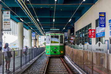 Obraz premium Busan, South Korea - 02 Sep, 2025 - Tourists boarding the Haeundae Beach Train at the seaside station, a popular attraction for coastal sightseeing in Busan.