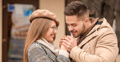 Portrait of happy young couple walking outdoors