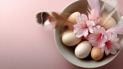 Colorful easter eggs nestled in a basket with delicate flowers and feathers on a soft pink background for spring celebration