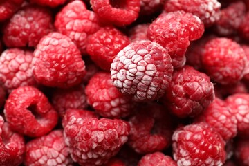 Frozen ripe raspberries as background, above view