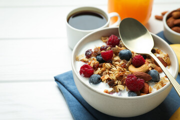 Healthy breakfast. Oatmeal with nuts, berries and milk on white wooden table, closeup. Space for text
