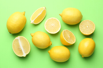 Fresh ripe lemons on light green background, flat lay