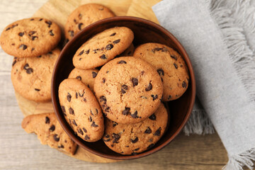 Delicious chocolate chip cookies in bowl on table, top view