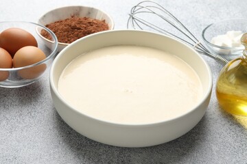 Fresh dough and ingredients on grey textured table, closeup