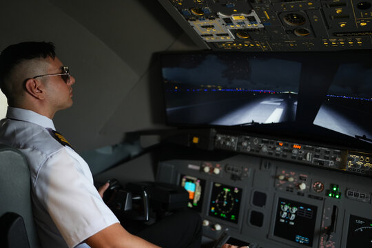 Airplan pilot controlling airplane throttle lever in simulator flight machine during the flight or take off or landing. View from inside the cabin or cockpit.