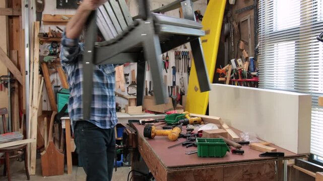 A carpenter assembles an Adirondack chair