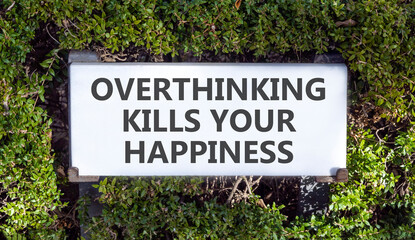 Overthinking kills your happiness symbol. Concept words Overthinking kills your happiness on road sign. Beautiful green trees background. Business overthinking kills happiness concept. Copy space.