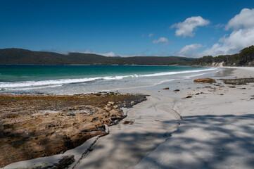 Coastal beach on Bruny Island with white sand, turquoise ocean and gentle waves, natural shoreline scene for travel marketing, tourism promotion, outdoor branding and destination advertising.
