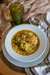 Homemade recipe for rice with chicken and broccoli on a dining table at home