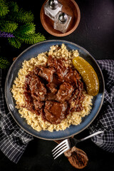 Chunky beef stew with savory sauce, served with bulgur groats.