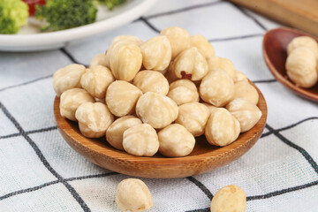 Roasted Macadamia Nuts - Healthy Unshelled Nut Snacks in Wooden Bowl