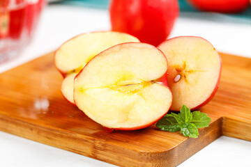 Fresh Red Apple Slices on Wooden Board with Mint © BuiVan