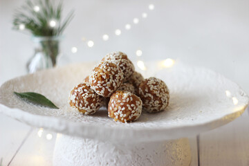 Sesame sweet balls in a ceramic vase on a table. Christmas decor.