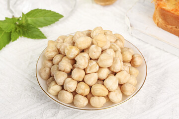 Whole Roasted Cashew Nuts in Bowl with Mint Garnish