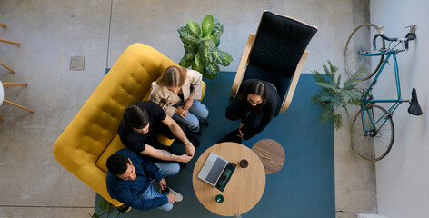 Diverse startup team collaborating in modern coworking office