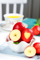 Fresh Red Apples with Heart Shape in White Bowl