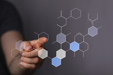 A hand interacting with a digital interface of molecular structure. Perfect for science and technology topics and futuristic concepts