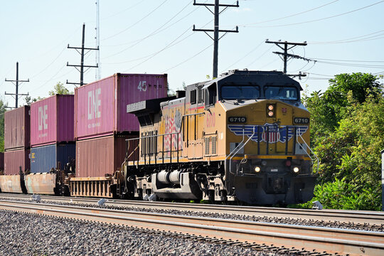 A single Union Pacific Railroad locomotive leads an intermodal freight train eastbound through northeastern Illinois.